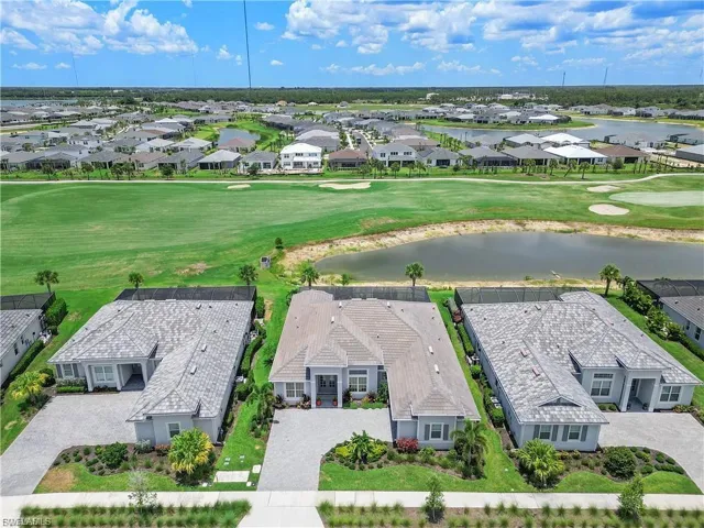 Single-story residence with a paved driveway, manicured landscaping, and a tile roof