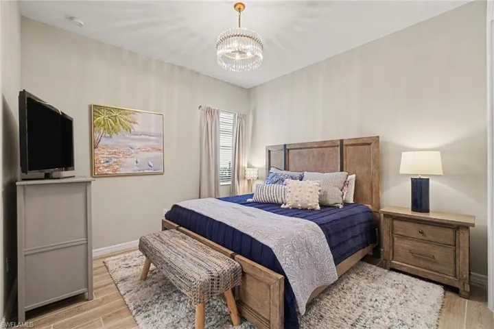Wood-finish flooring, recessed lighting, ceiling-mounted light fixture, and window with blinds