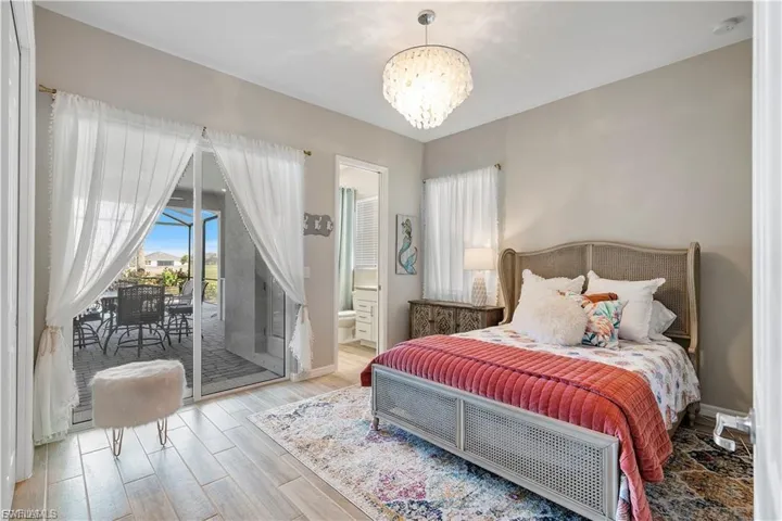 Recessed lighting, light wood-finish flooring, and a decorative chandelier