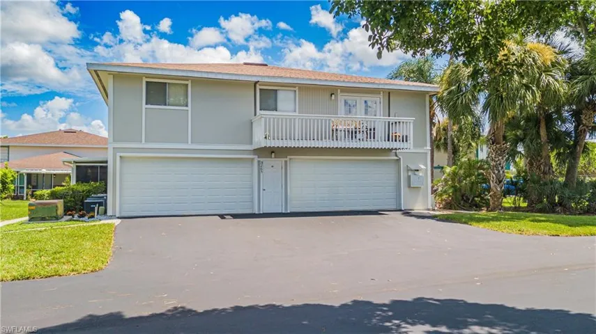 View of front facade of townhouse with attached garage