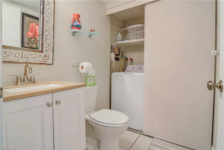 Bathroom with full sized washer and additional storage