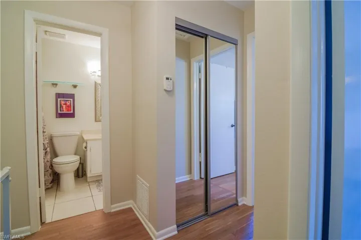 Corridor with light hardwood / wood-style flooring