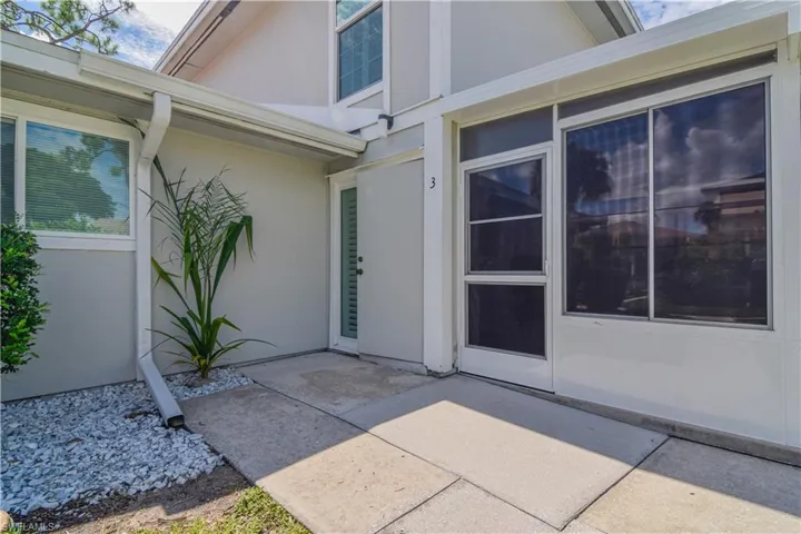 Front entrance to property with a quiet patio area and adjacent door to newly installed Florida room