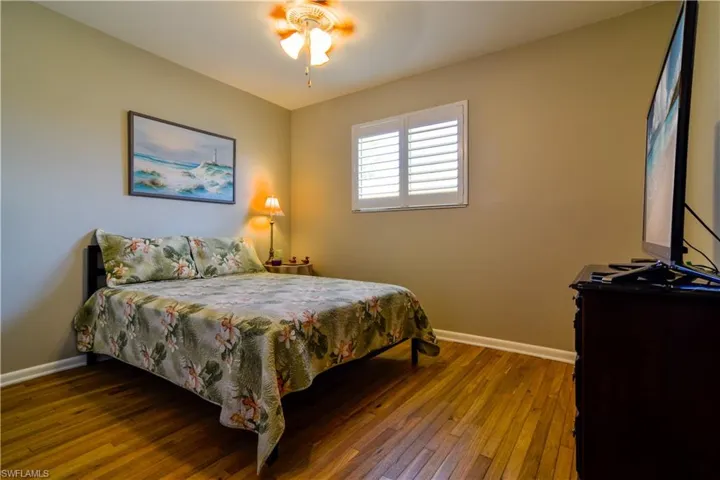 Bedroom featuring ceiling fan and wood-type flooring