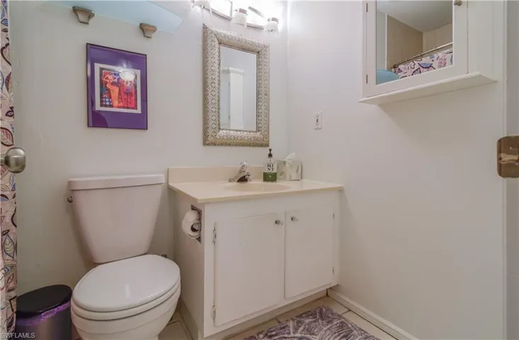 Upstairs full bathroom with new light fixture and combination tub and shower