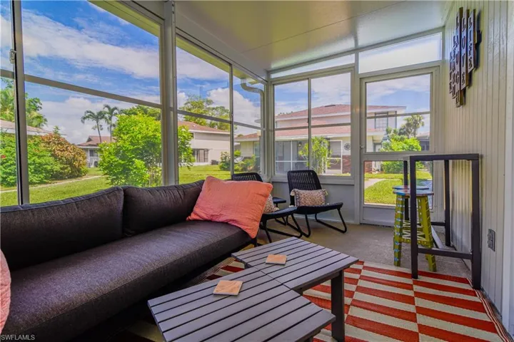 Sunroom overlooking grassy courtyard and other townhomes