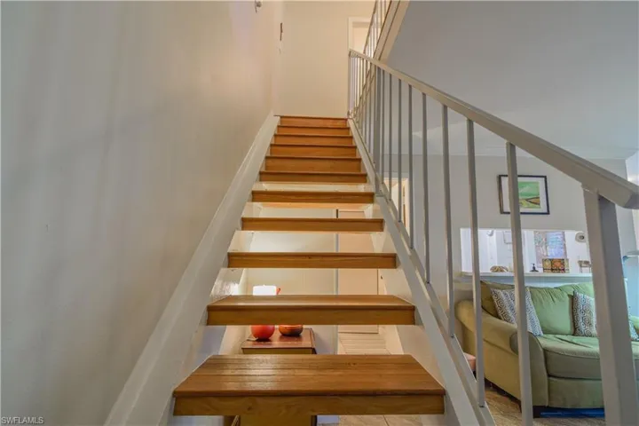 Floating stairway with warm wooden treads