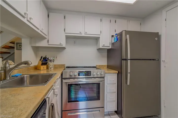 Kitchen featuring tile floors, and updated stainless steel appliances