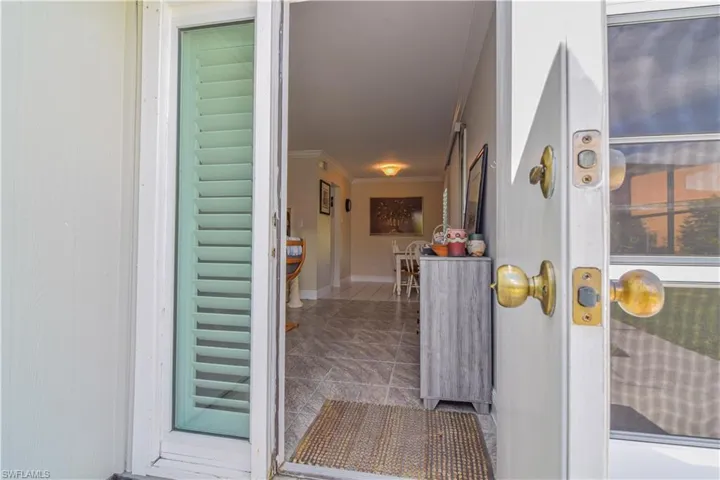 Front entrance to property with a quiet patio area and adjacent door to newly installed Florida room