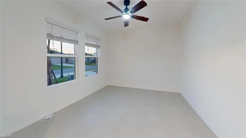 Recessed lighting, ceiling fan with integrated light, two windows with blinds, and light-toned flooring