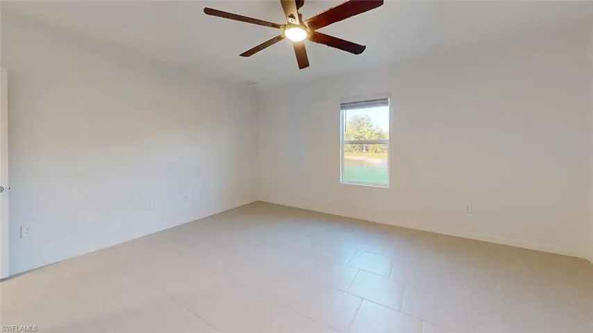Recessed lighting, wood-finish ceiling fan, tiled flooring, and a window with outdoor scenery
