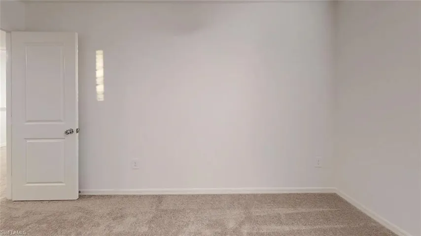 Wall-to-wall carpeting with light neutral walls