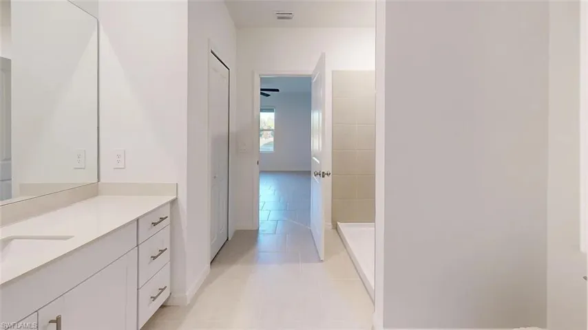 Spacious vanity with an integrated sink and light-toned countertop