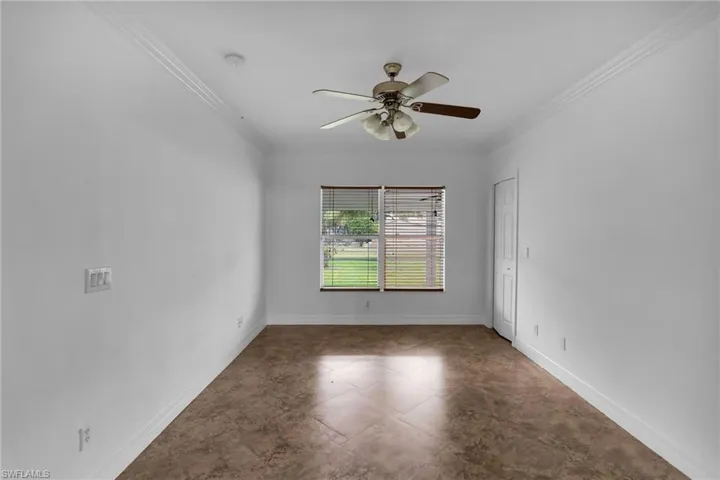 Unfurnished room featuring ceiling fan and ornamental molding