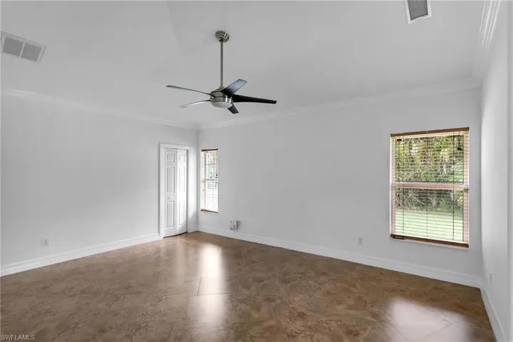 Unfurnished room with ceiling fan and ornamental molding