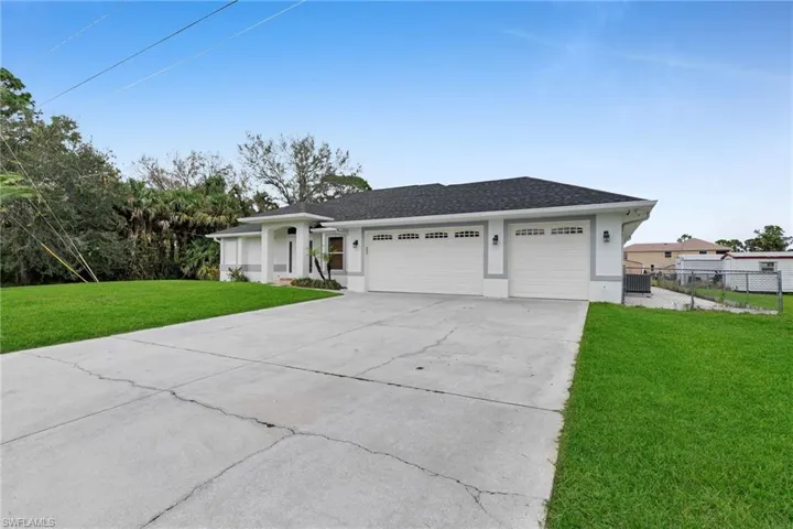 Ranch-style home with a garage and a front yard