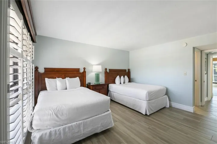 Bedroom with wood finished floors and baseboards