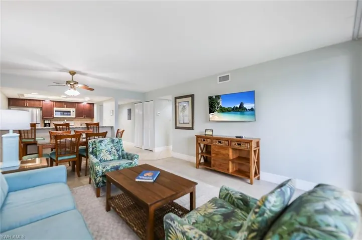 Living area featuring light tile patterned floors, recessed lighting, and a ceiling fan
