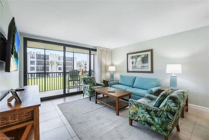 Living area featuring expansive windows and light tile patterned flooring