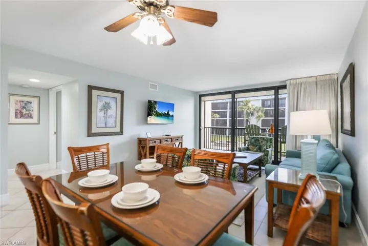 Dining space with ceiling fan and light tile patterned floors