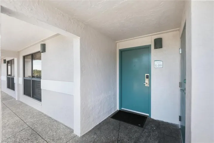 Property entrance featuring stucco siding