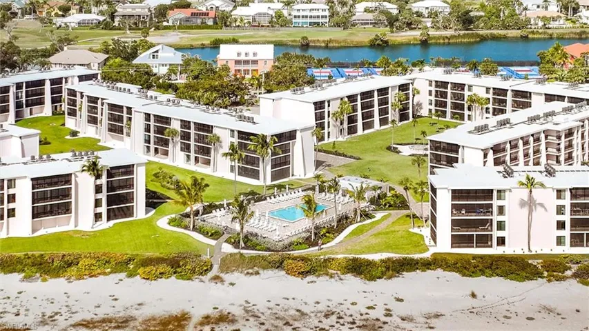 Drone / aerial view of a nearby body of water and apartment complex