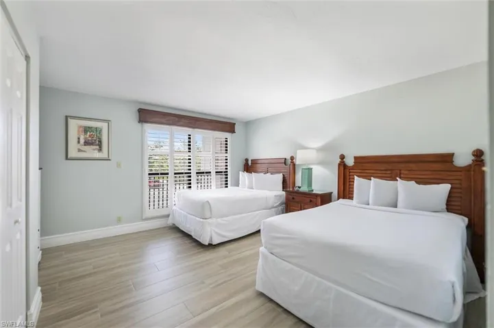 Bedroom with light wood-type flooring and a closet