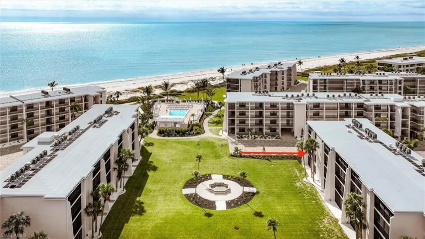 Drone / aerial view of apartment complex / building and expansive beach