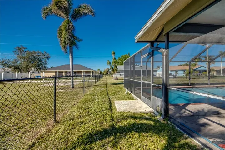 View of yard with a lanai and a fenced in pool