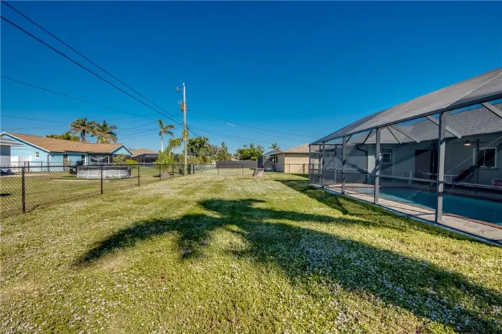 View of yard featuring a fenced in pool and a lanai