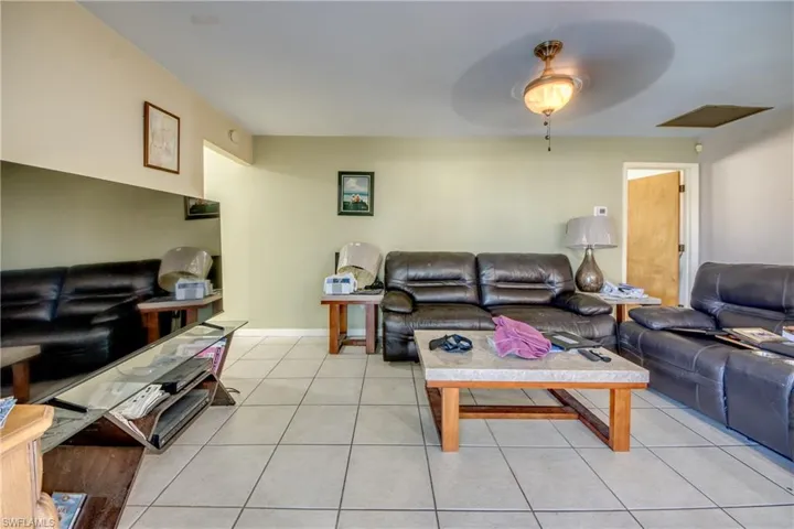Living room featuring ceiling fan and light tile patterned floors