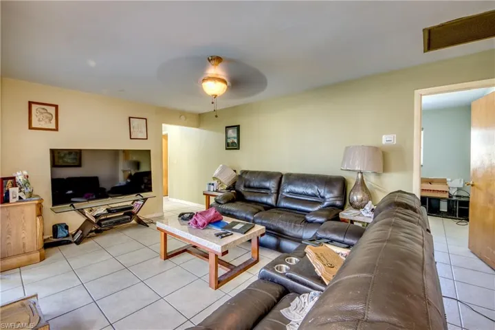 Living room featuring ceiling fan and light tile patterned floors