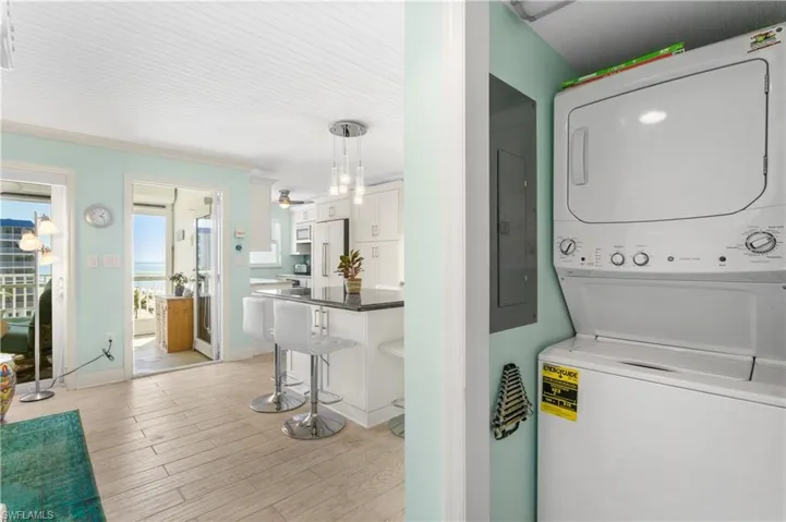 Laundry closet with additional storage.