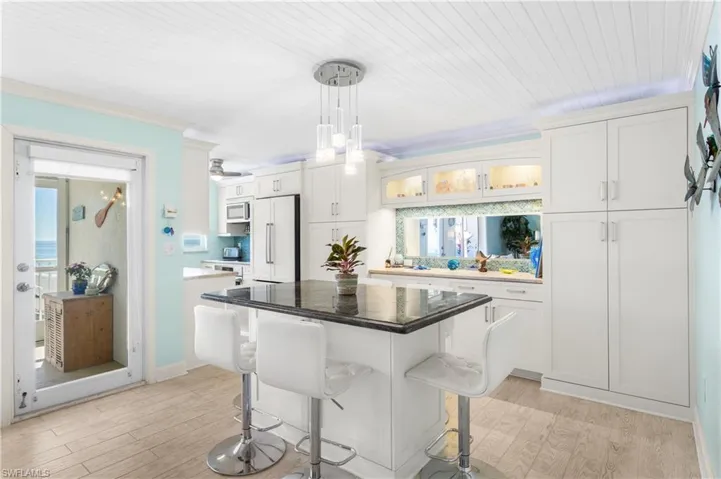 Large island with cabinetry underneath, granite counter top on Island.