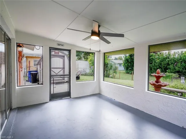 Unfurnished sunroom with ceiling fan and healthy amount of natural light