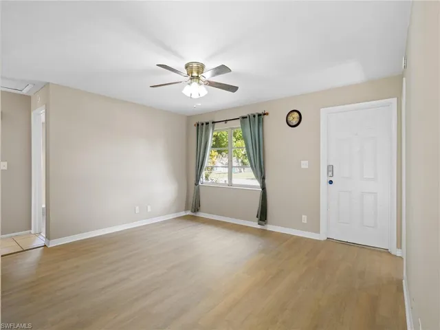 Entrance foyer with light wood-type flooring and ceiling fan