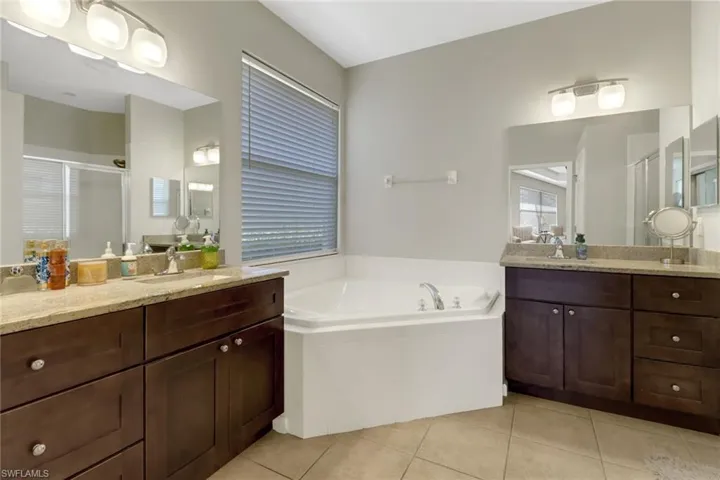 Bathroom with vanity, independent shower and bath, and tile patterned flooring