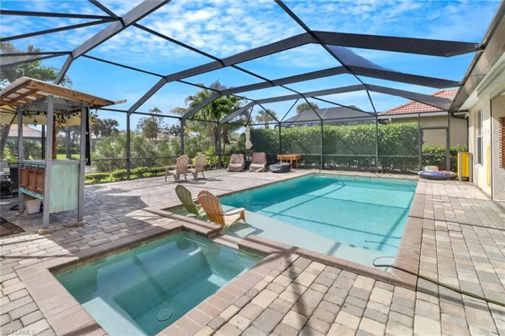 View of pool with a patio and a lanai
