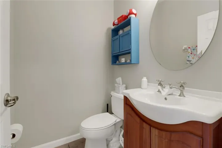 Bathroom with vanity, toilet, and tile patterned flooring
