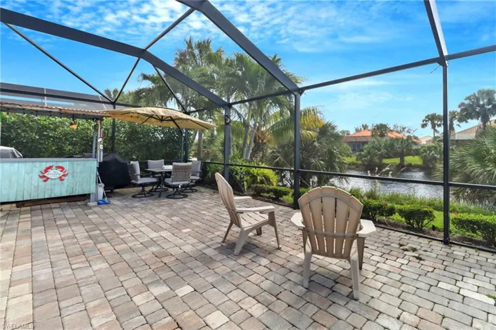 View of patio with a water view and glass enclosure