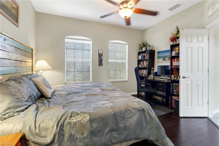Bedroom featuring dark wood-type flooring and ceiling fan