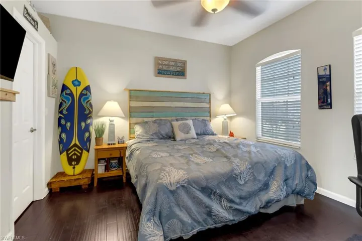 Bedroom featuring ceiling fan and dark hardwood / wood-style floors