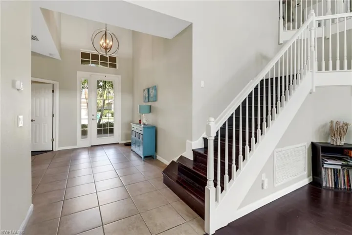 Entryway with a chandelier, a high ceiling, and light tile patterned floors