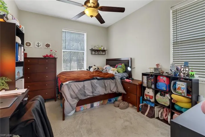 Bedroom with ceiling fan and carpet