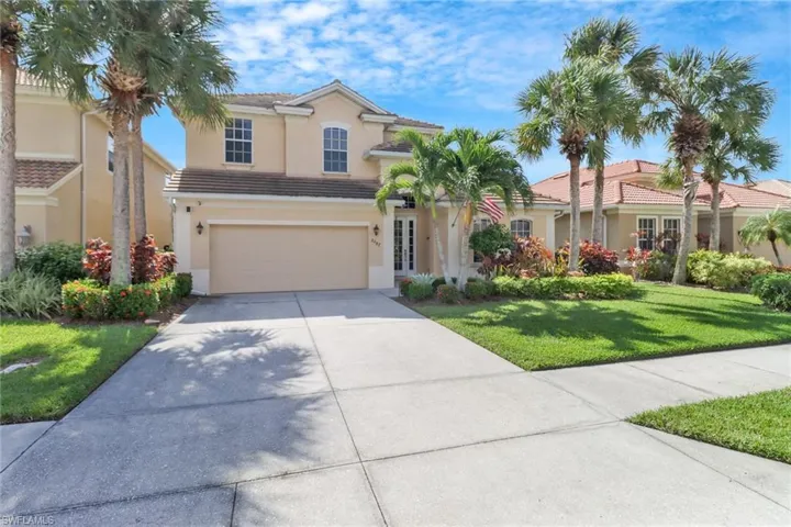 View of front of home with a front lawn and a garage