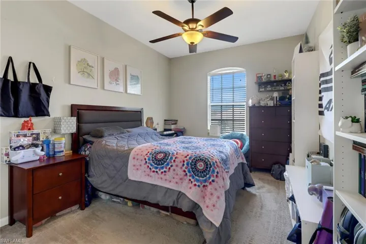 Bedroom featuring ceiling fan and light carpet