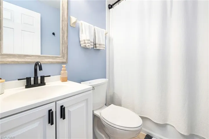 Bathroom featuring vanity and shower / bath combo