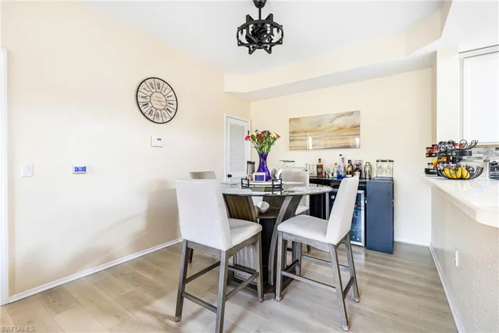 Dining space with light wood-style flooring and beverage cooler