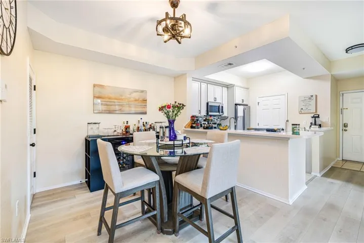 Dining space featuring light wood-style floors and hanging lights