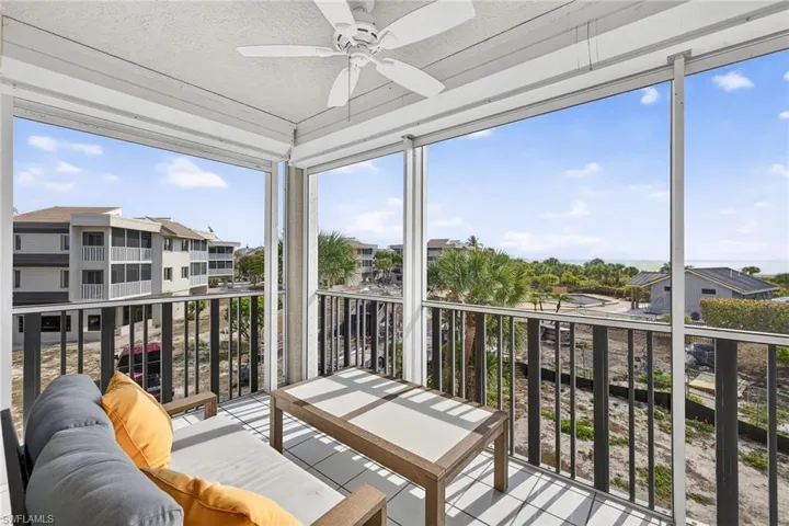 Sunroom with floor to ceiling windows and a textured ceiling
